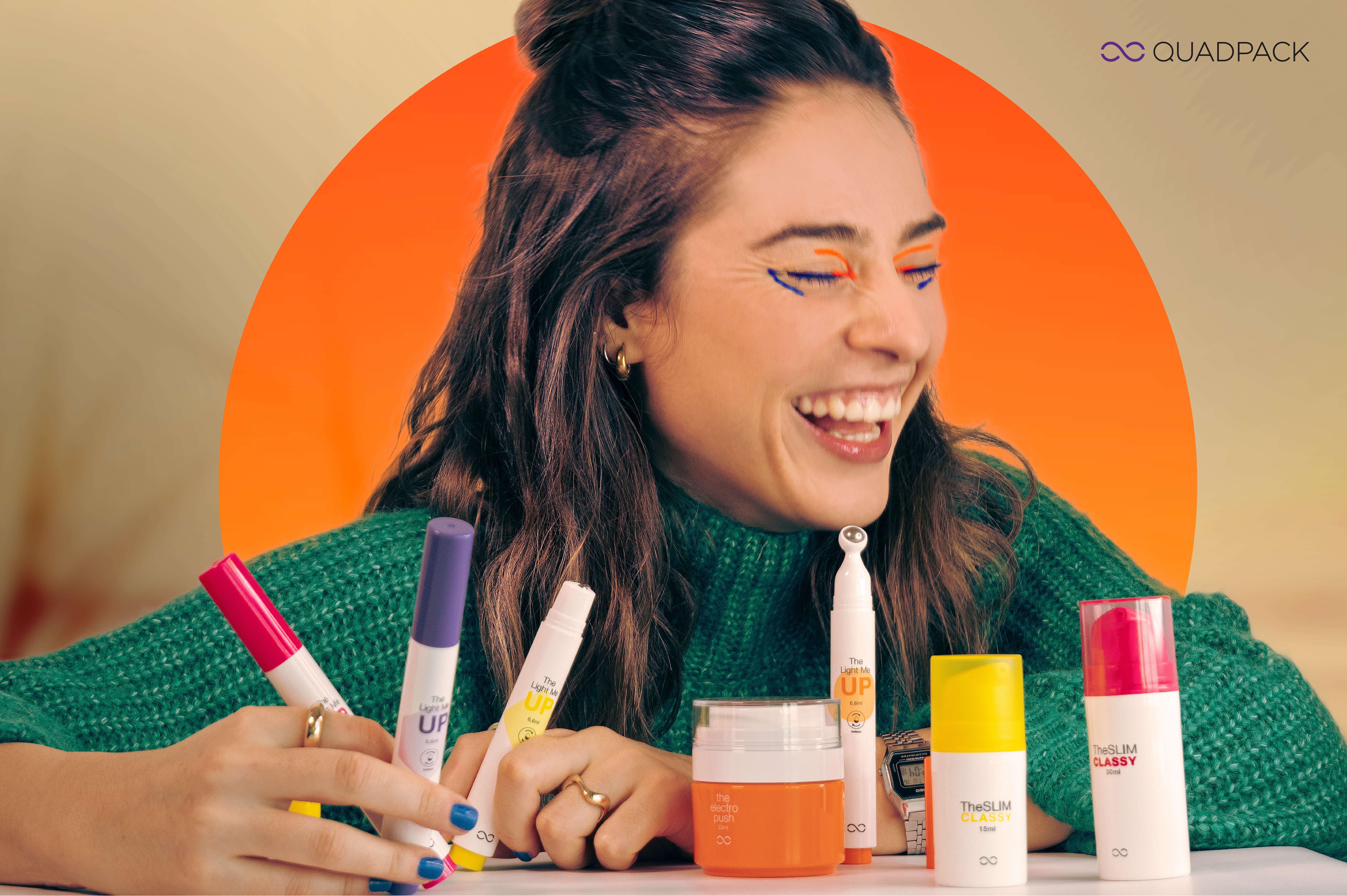 Woman laughing holding colorful cosmetic packaging samples