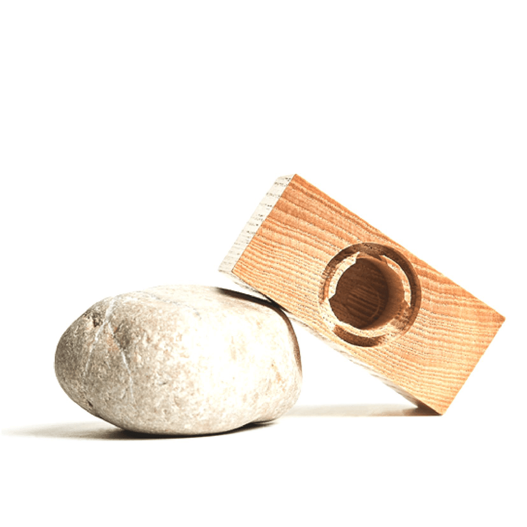 Wooden Fragrance Cap leaning on a stone